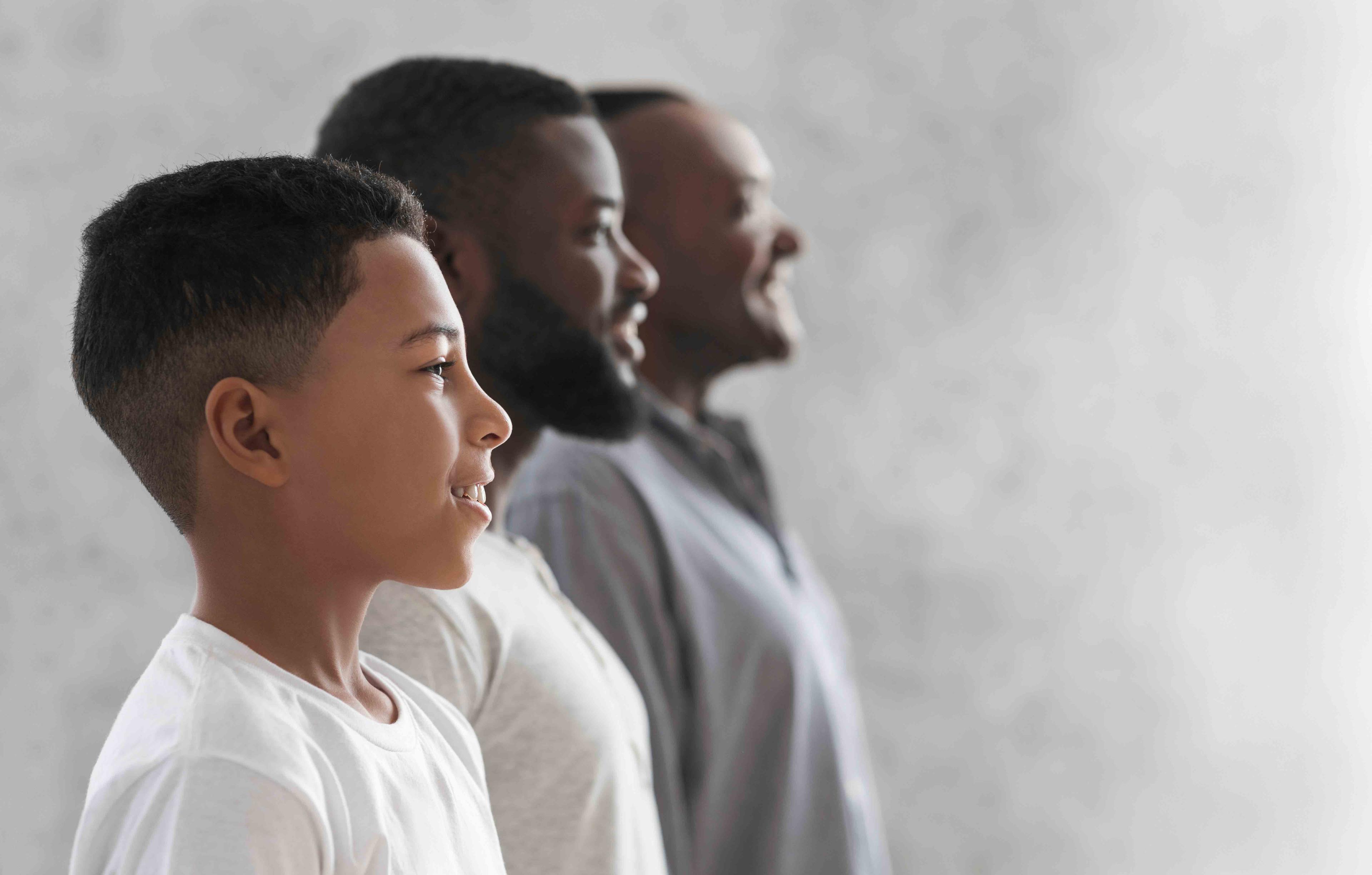 Side profile portraits of youth, adult and elderly male of African descent depicting role of testosterone and DHT in men's health and development.