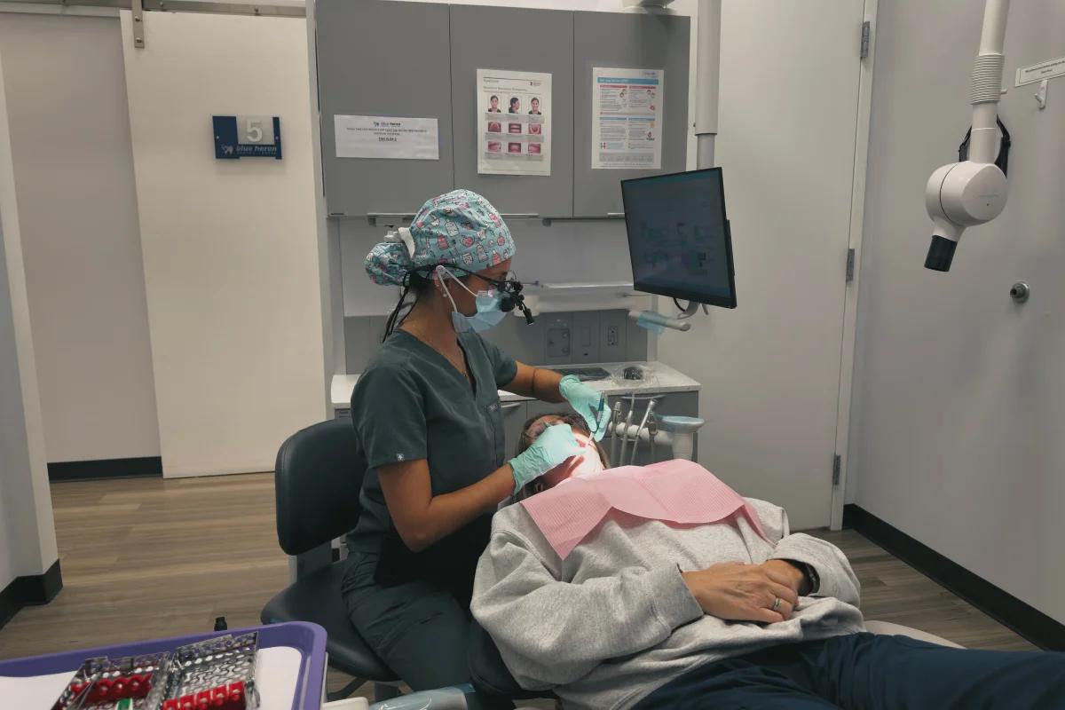 Hygienist working with patient