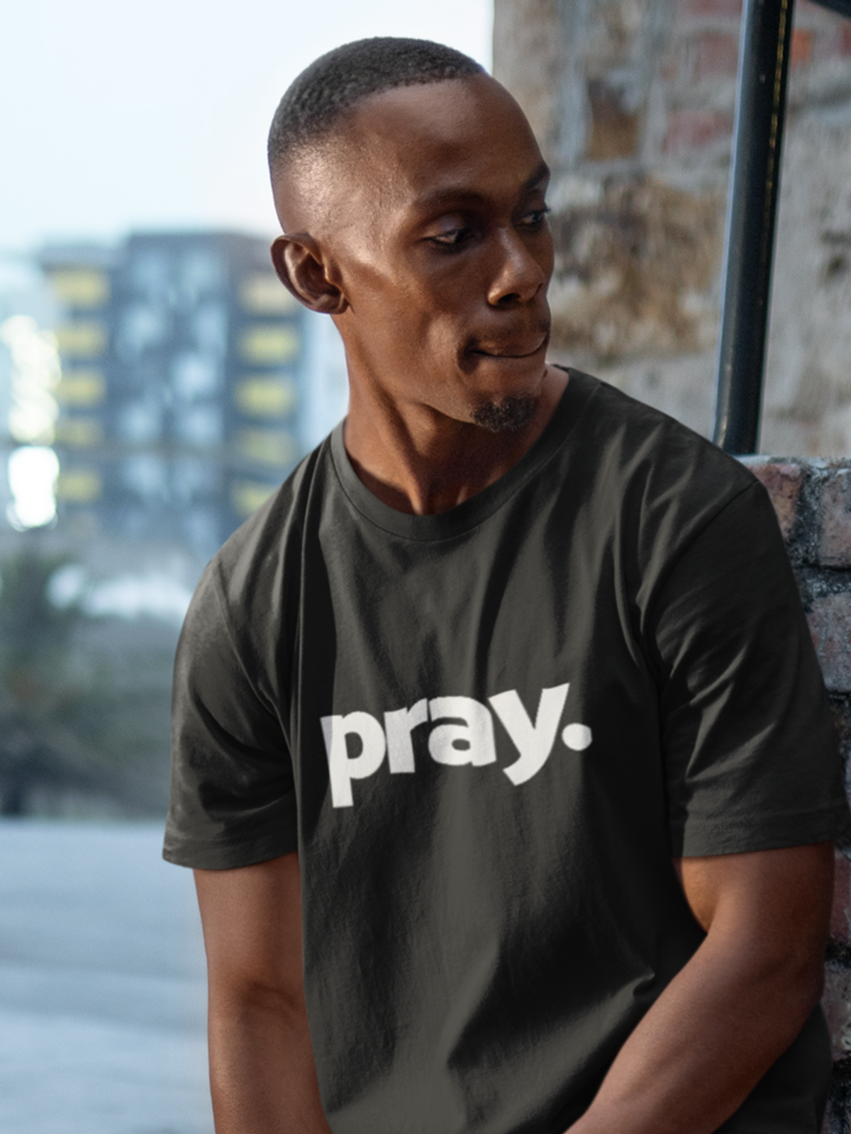 Man wearing black shirt with the word "Pray" on front