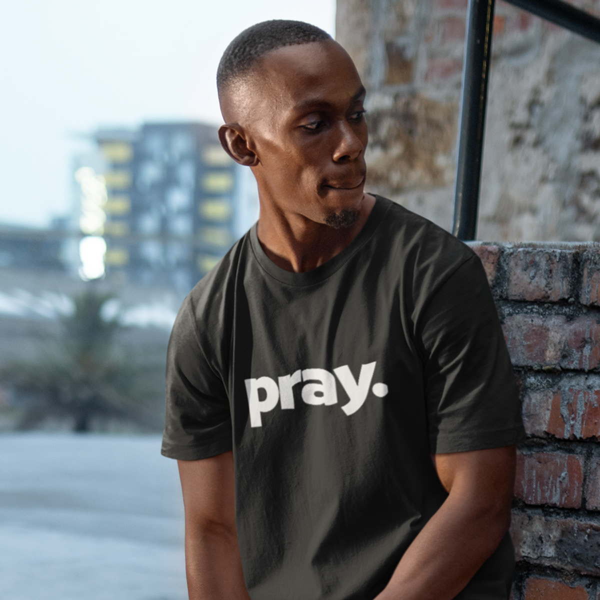 Man wearing black shirt with the word "Pray" on front