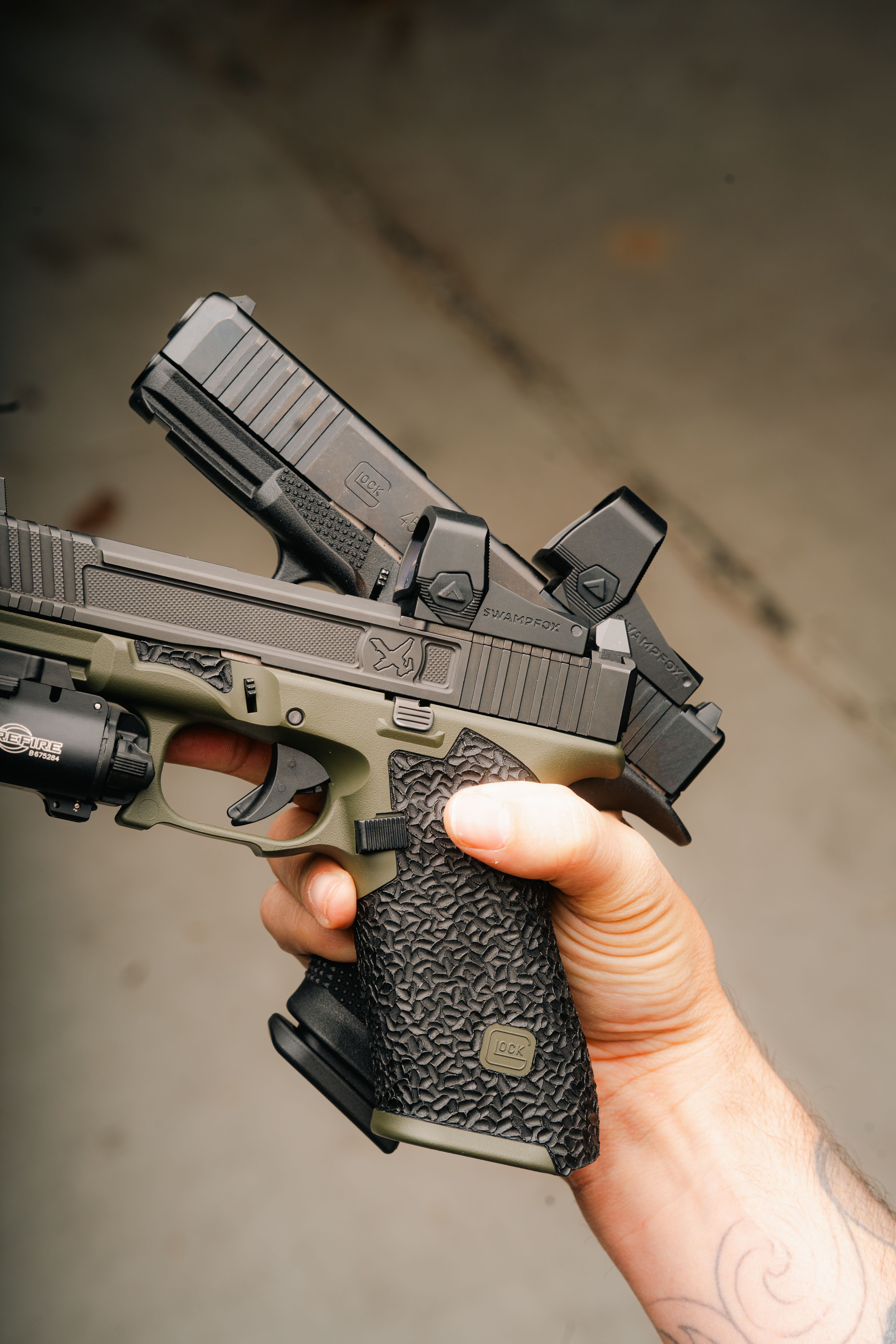 Two Glocks side by side — one with a Liberty II, one with a Justice II