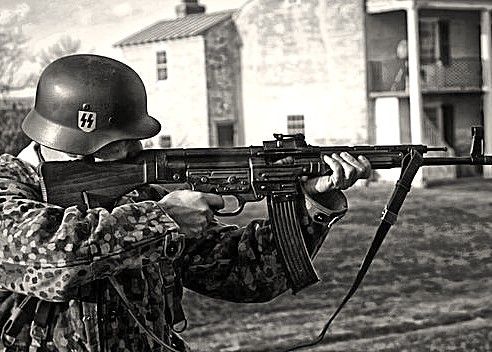 German soldier in the field armed with an StG 44 — the weapon that solved the range gap between bolt rifles and submachine guns