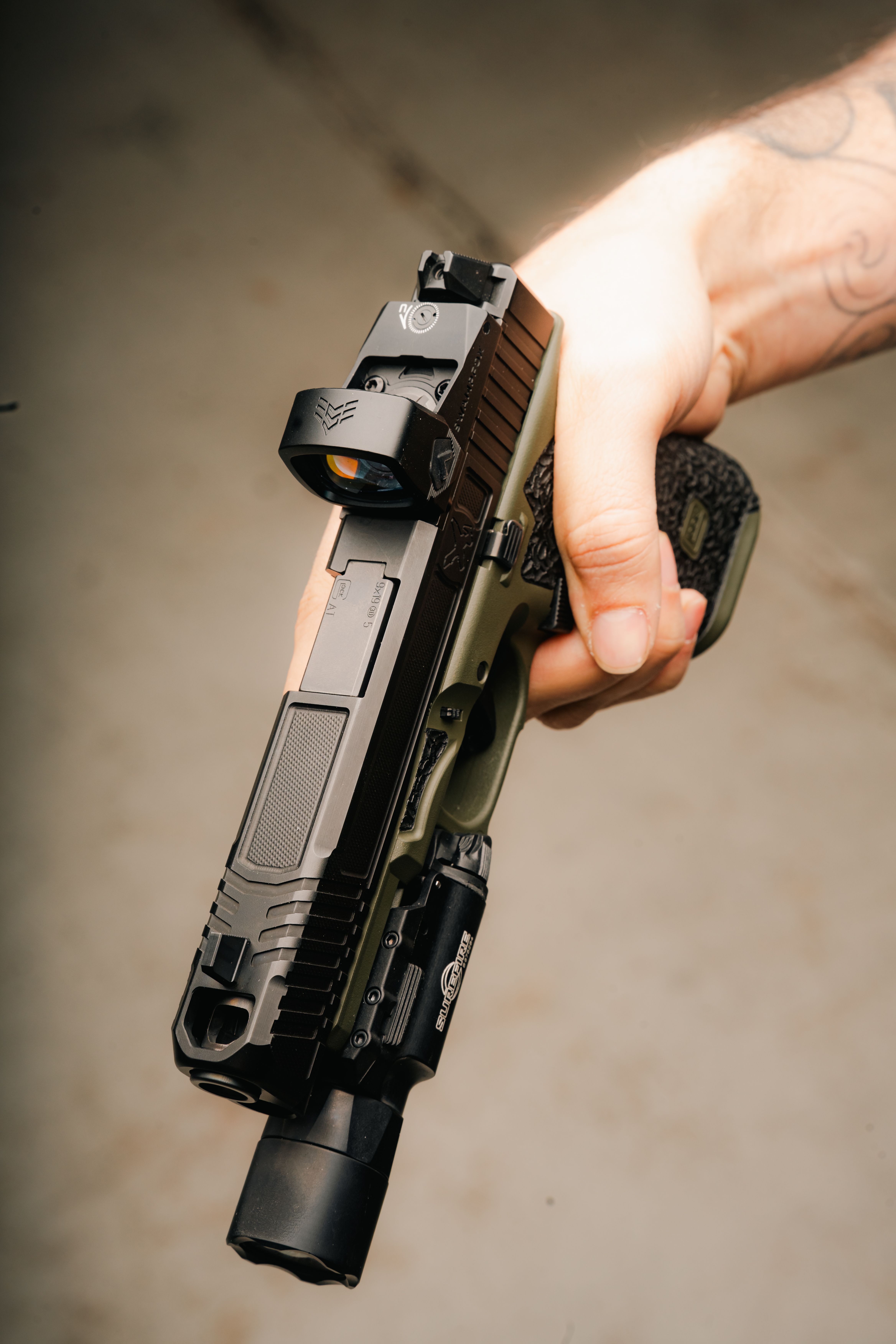 Top-down view of a Glock with a Liberty II red dot mounted on it
