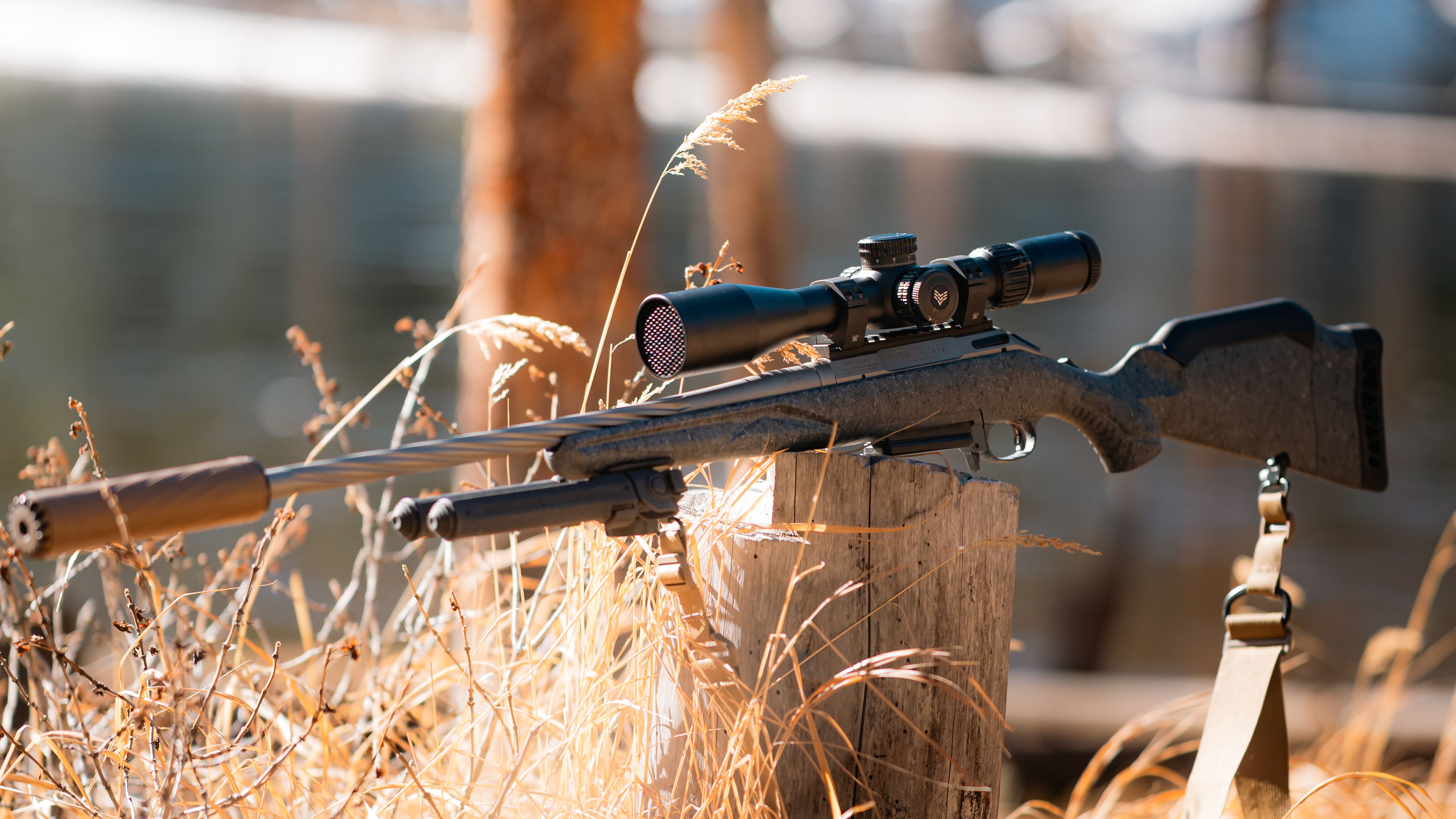 Shooter dialing in gear and preparing at the range