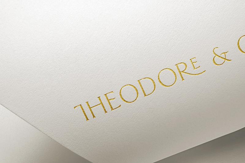 Cream background with gold foil letterpress saying Theodore & Co