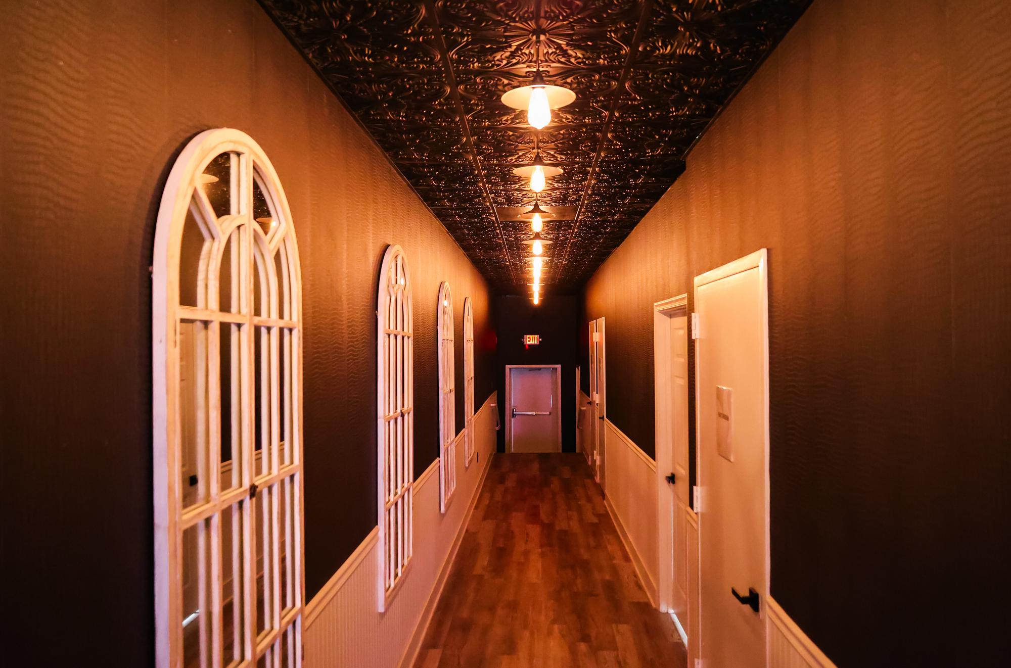 The hallway running back toward the bathrooms