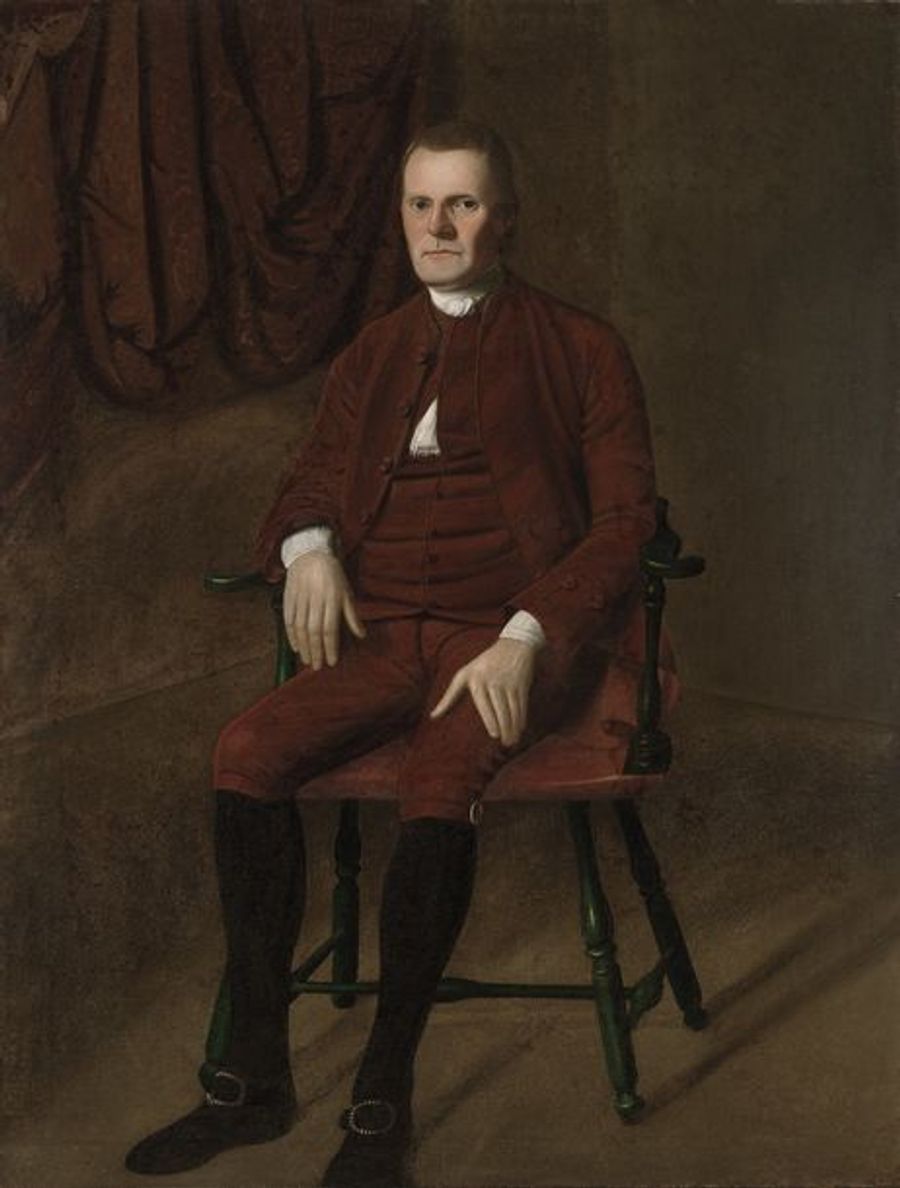 Roger Sherman seated in a wooden chair, wearing a reddish-brown suit, in Ralph Earl’s portrait.