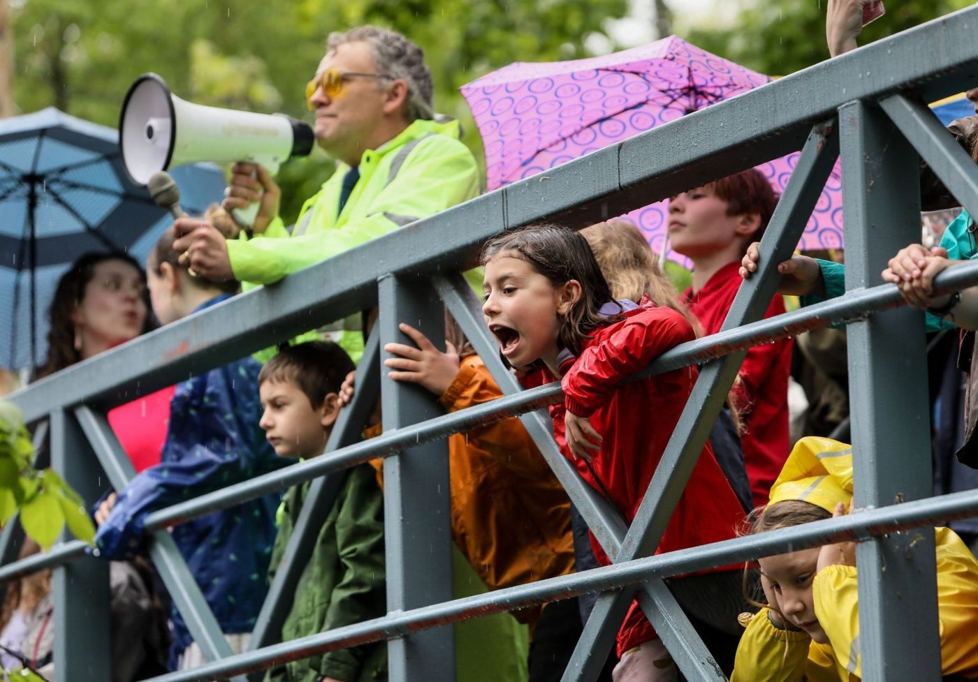 Outdoor crowd gathered along the bridge/river path with strong civic-festival context.