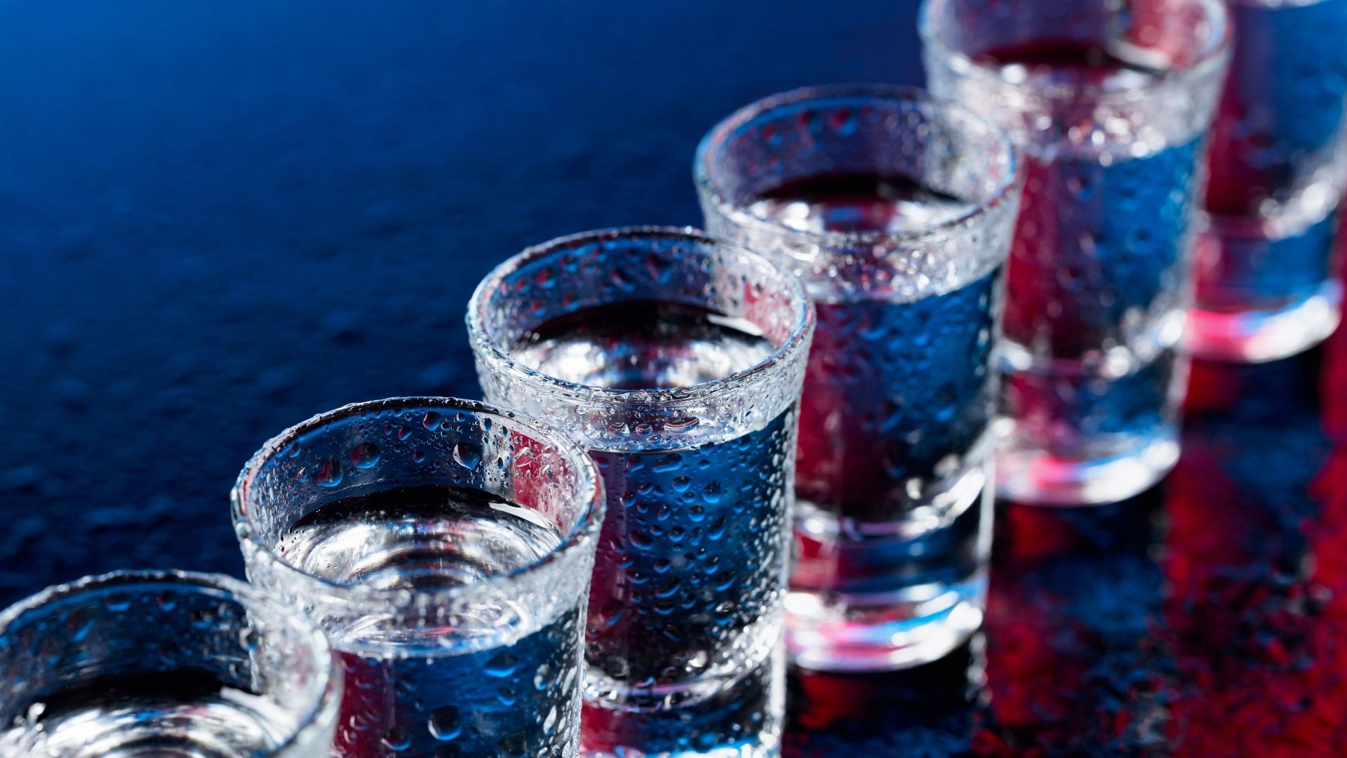 shots of vodka lined up on the bar