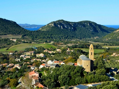 the island of corsica and a small town on the sea