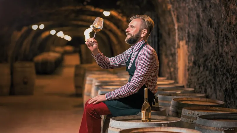 wine tasting in a wine aging cellar by a winemaker