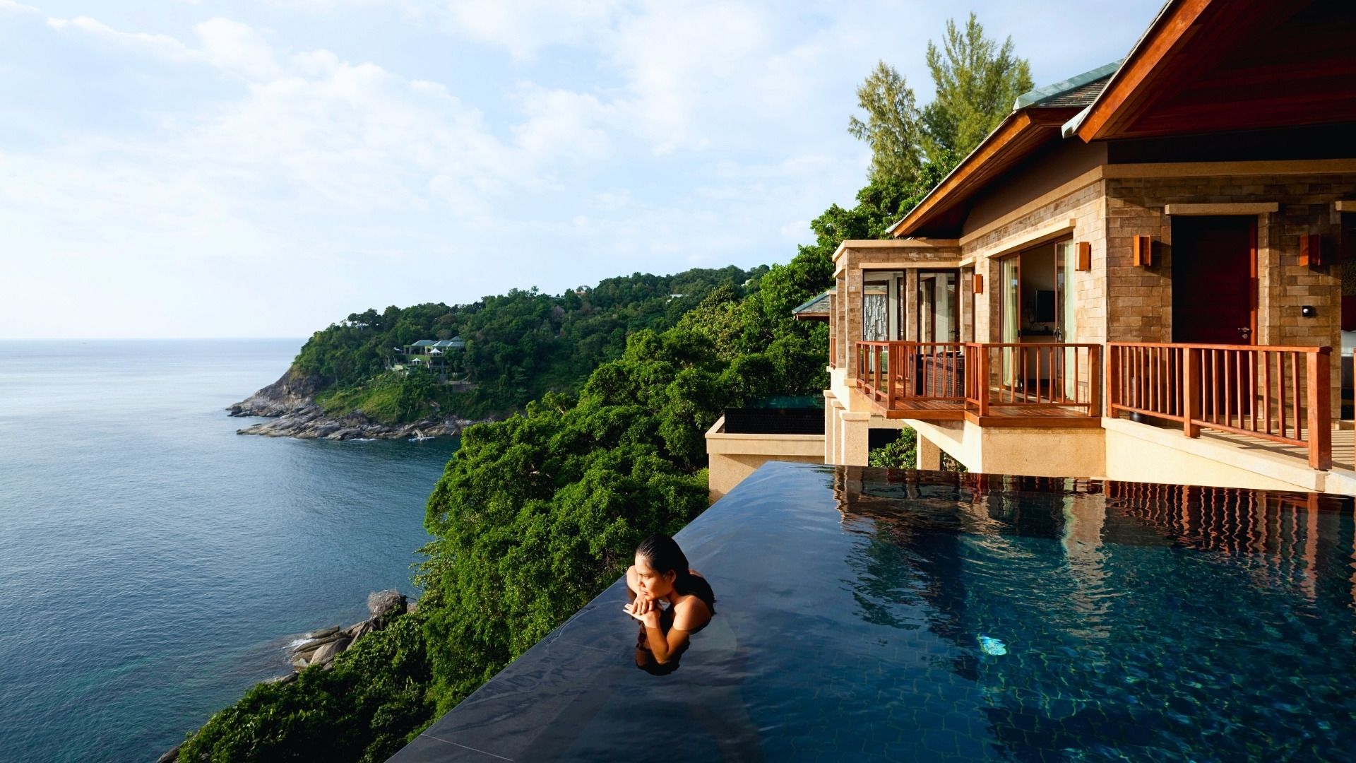 beautiful hotel cliffside in thailand with a pool and a luxury villa