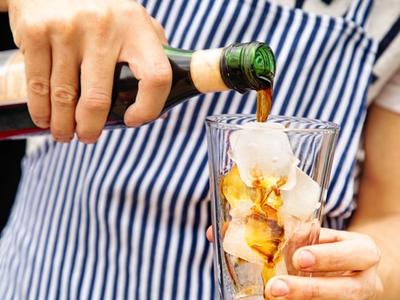 pouring fernet branca into a glass over ice