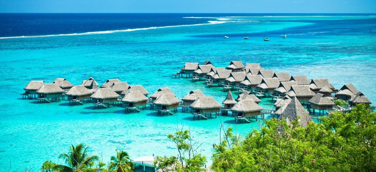 luxury hotel in the islands with its chain of huts extending over the water