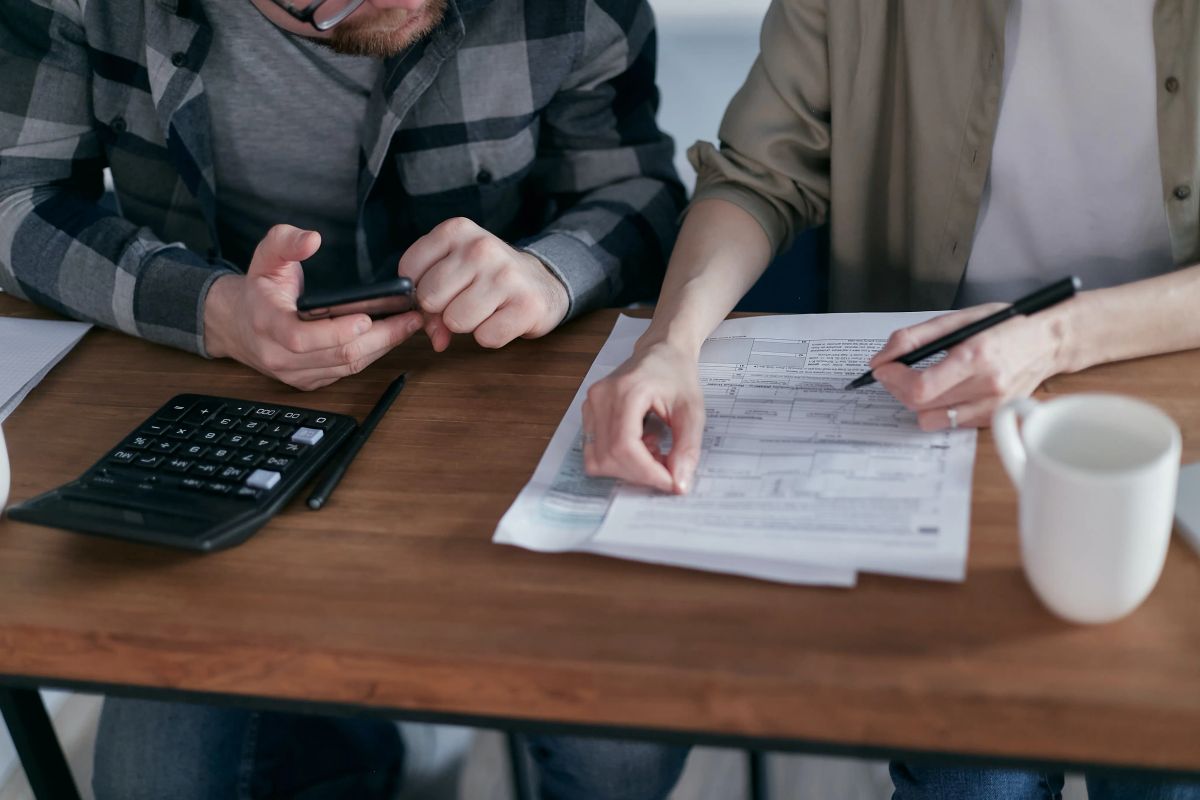 two individuals discussing calculations