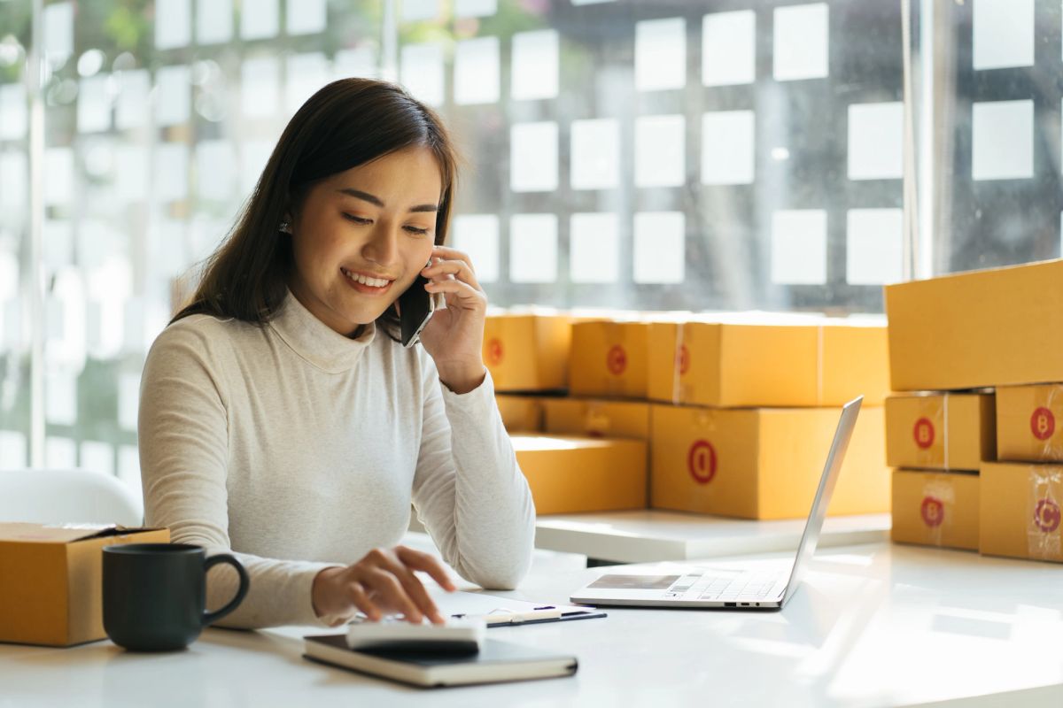 woman having coffee while taking a call