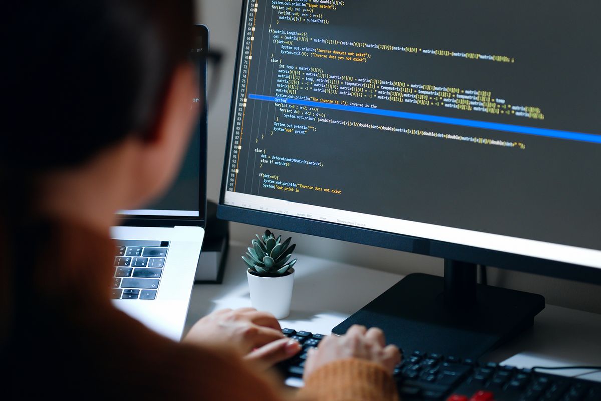 woman coding on the computer