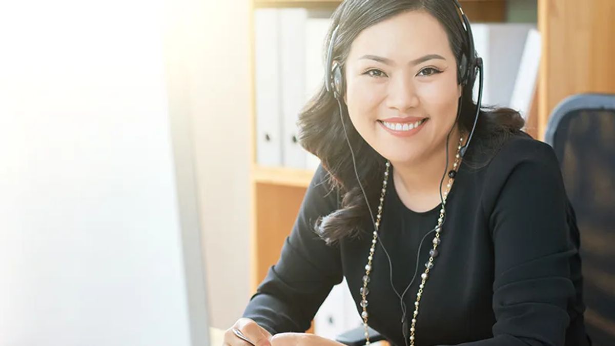 woman with headset smiling