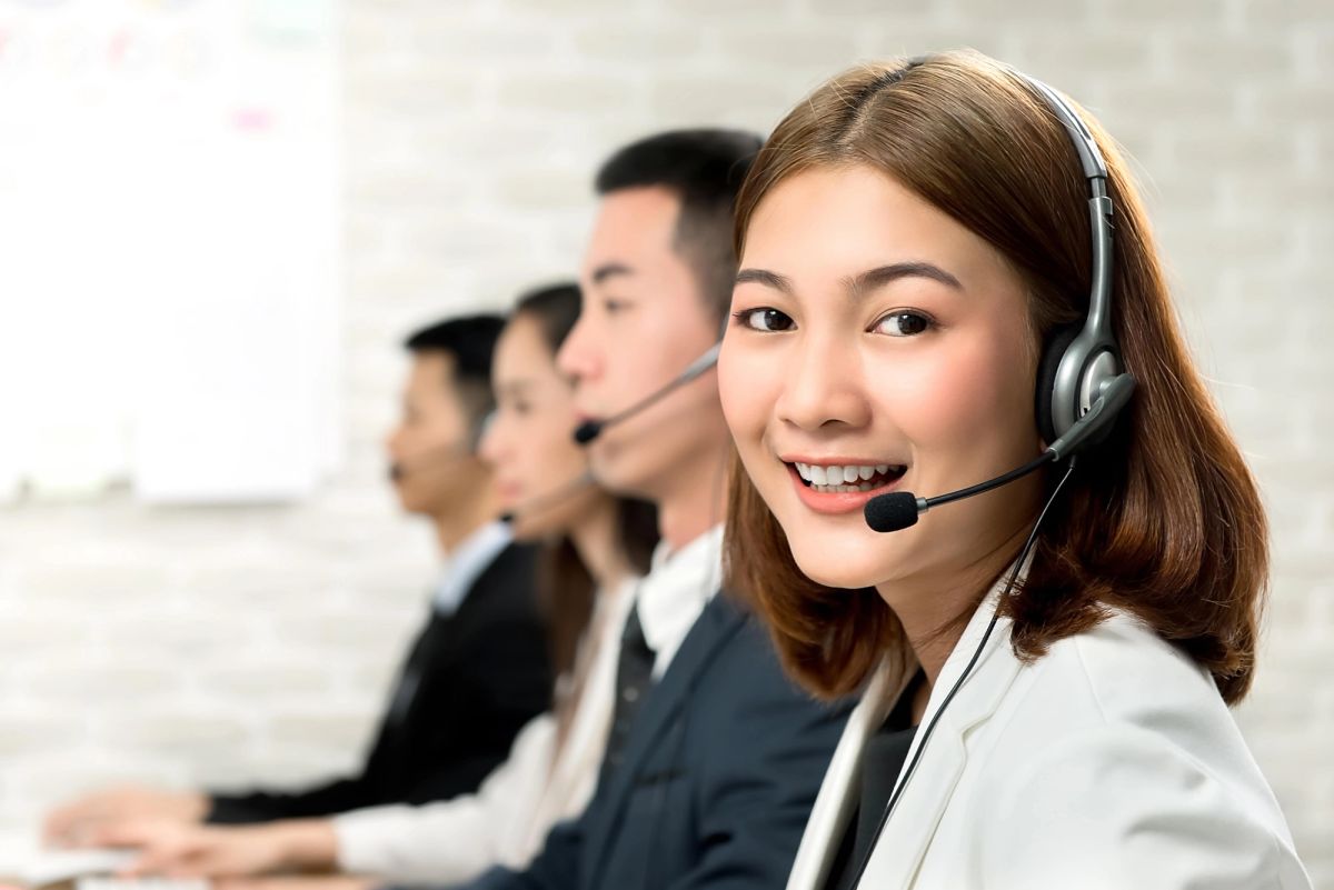 multiple people on BPO workstation with one looking at camera