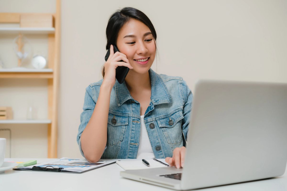 woman on call while on laptop