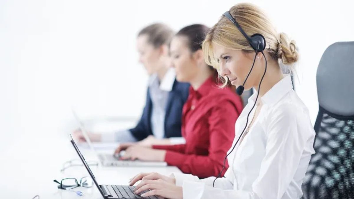 blonde woman wearing headset while on computer