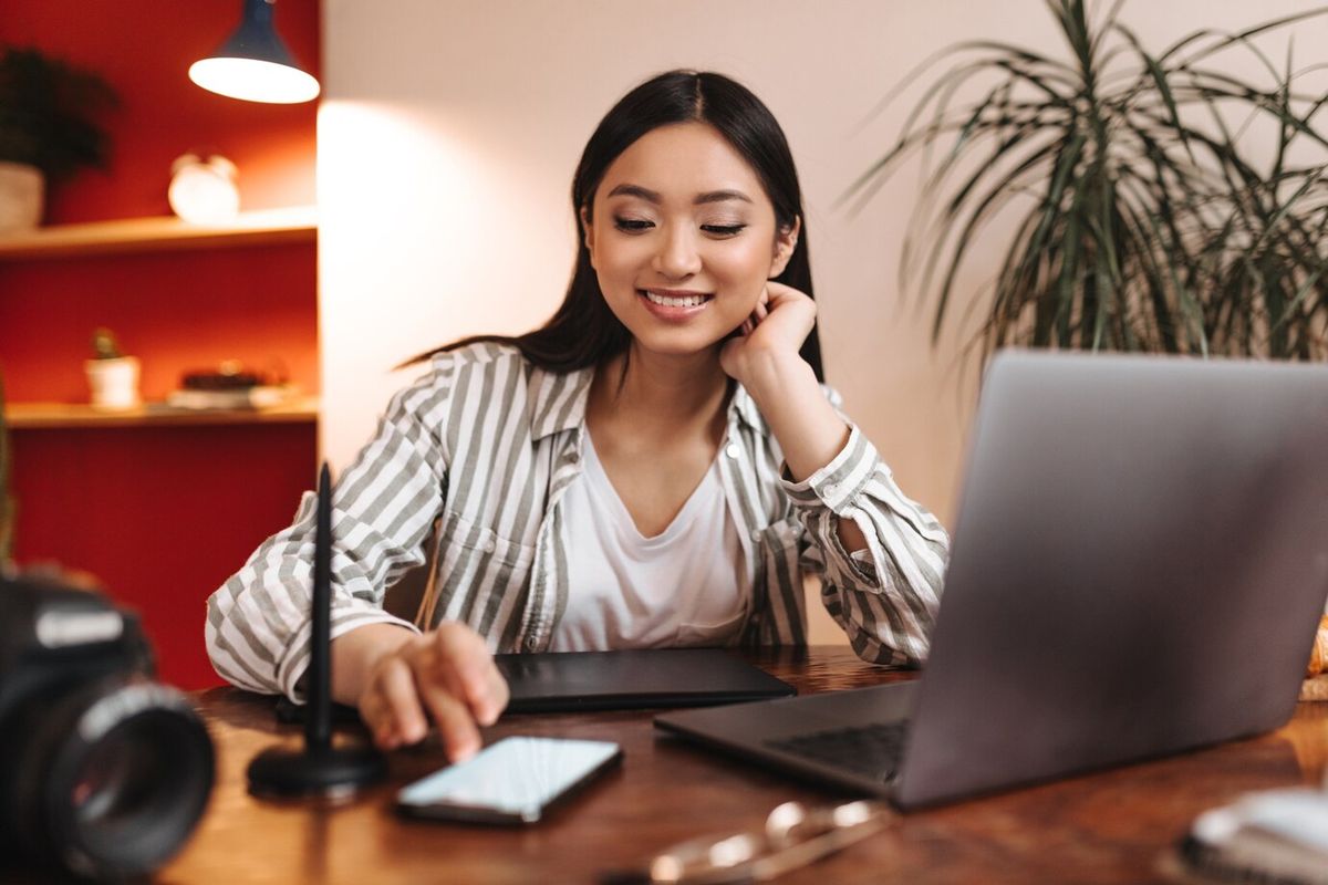 woman with striped shirt using a phone