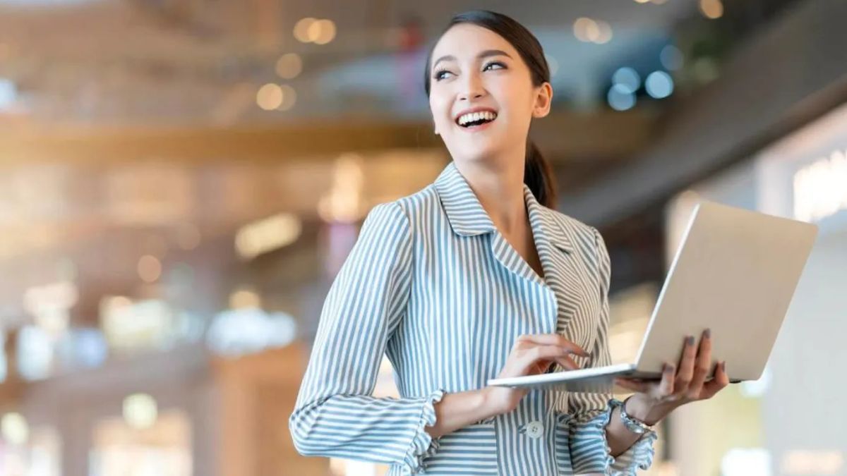 woman with laptop smiling