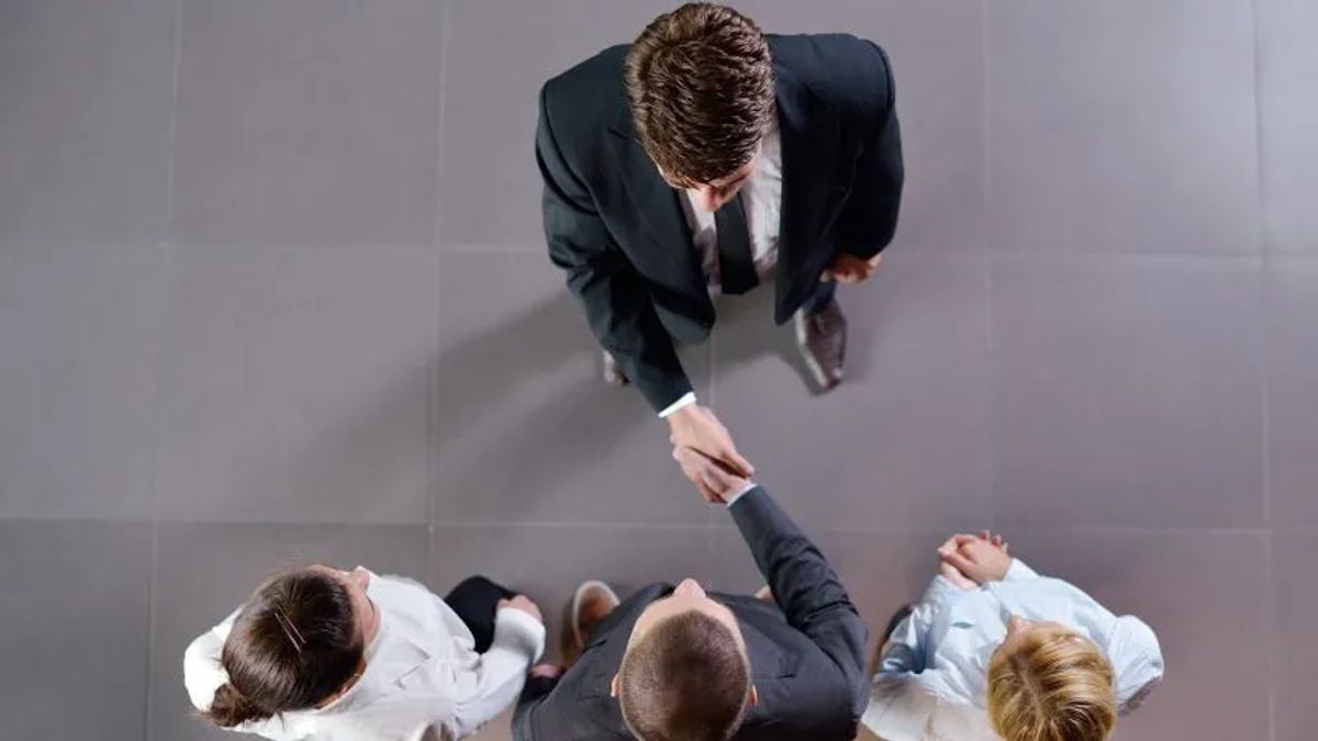 people shaking hands top view