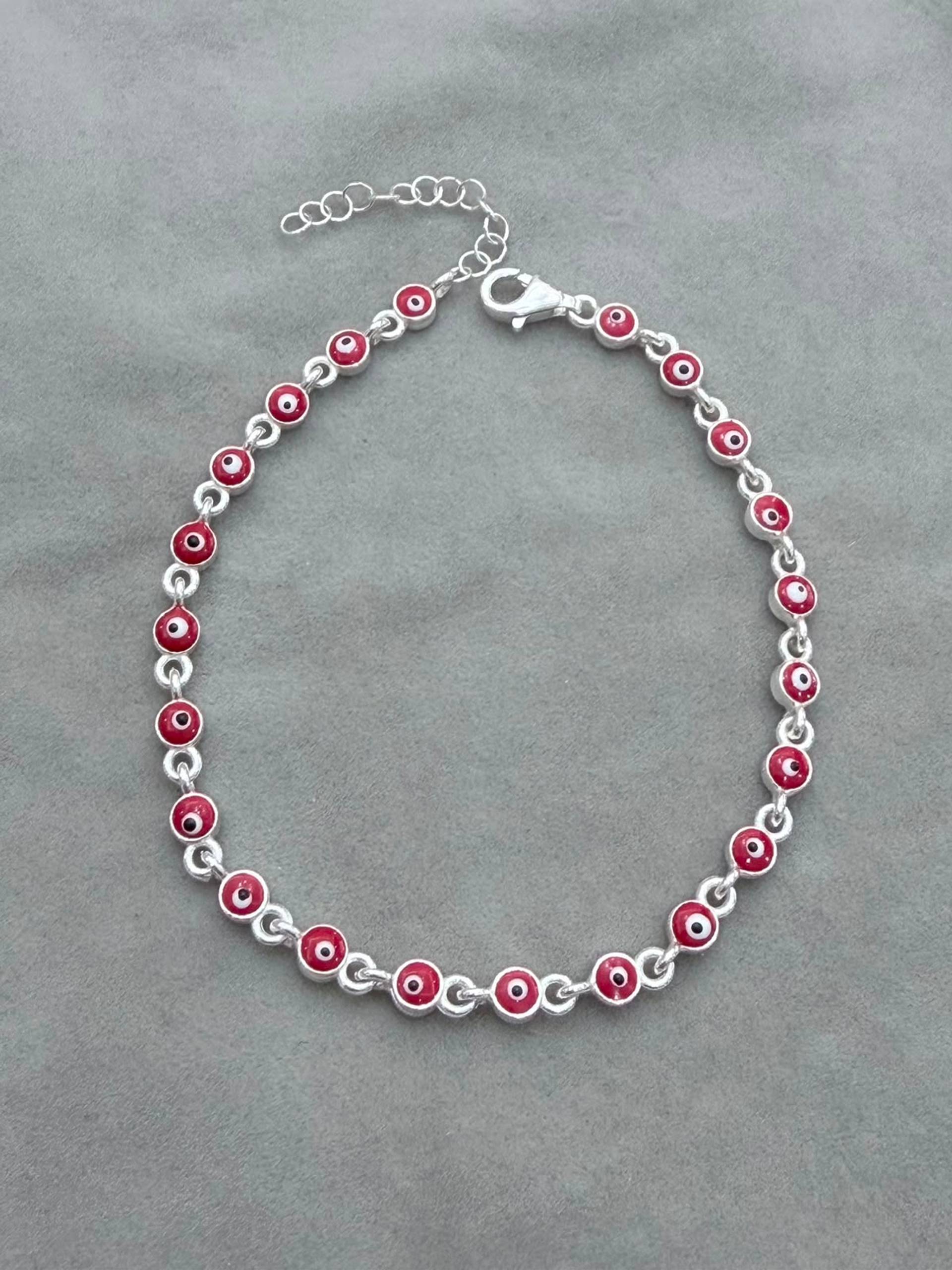 Pulsera eslabón circulares ojitos rojos