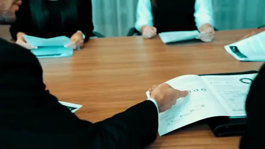 Briefing documents on a boardroom table, from the campaign film