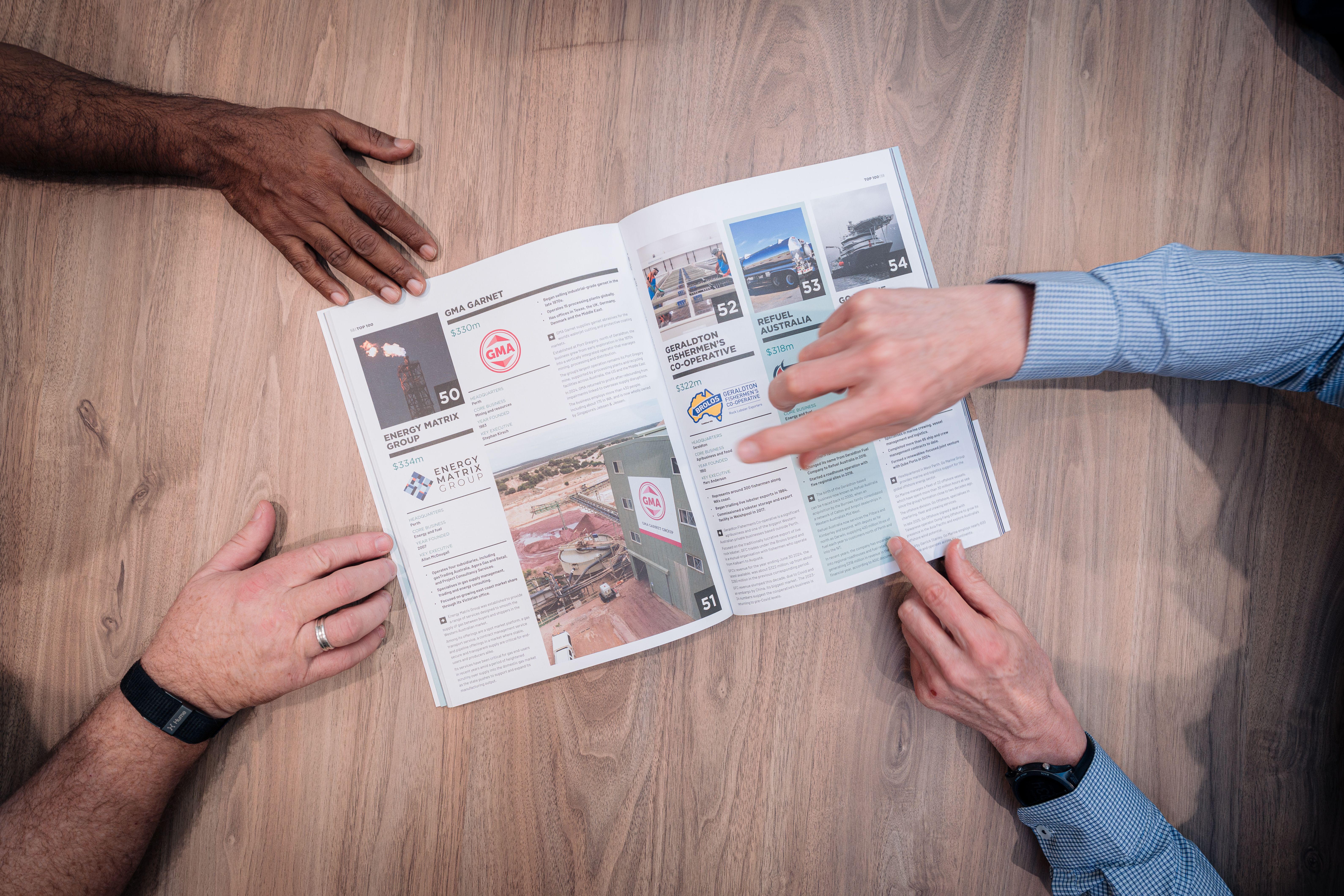 People overlooking a news article