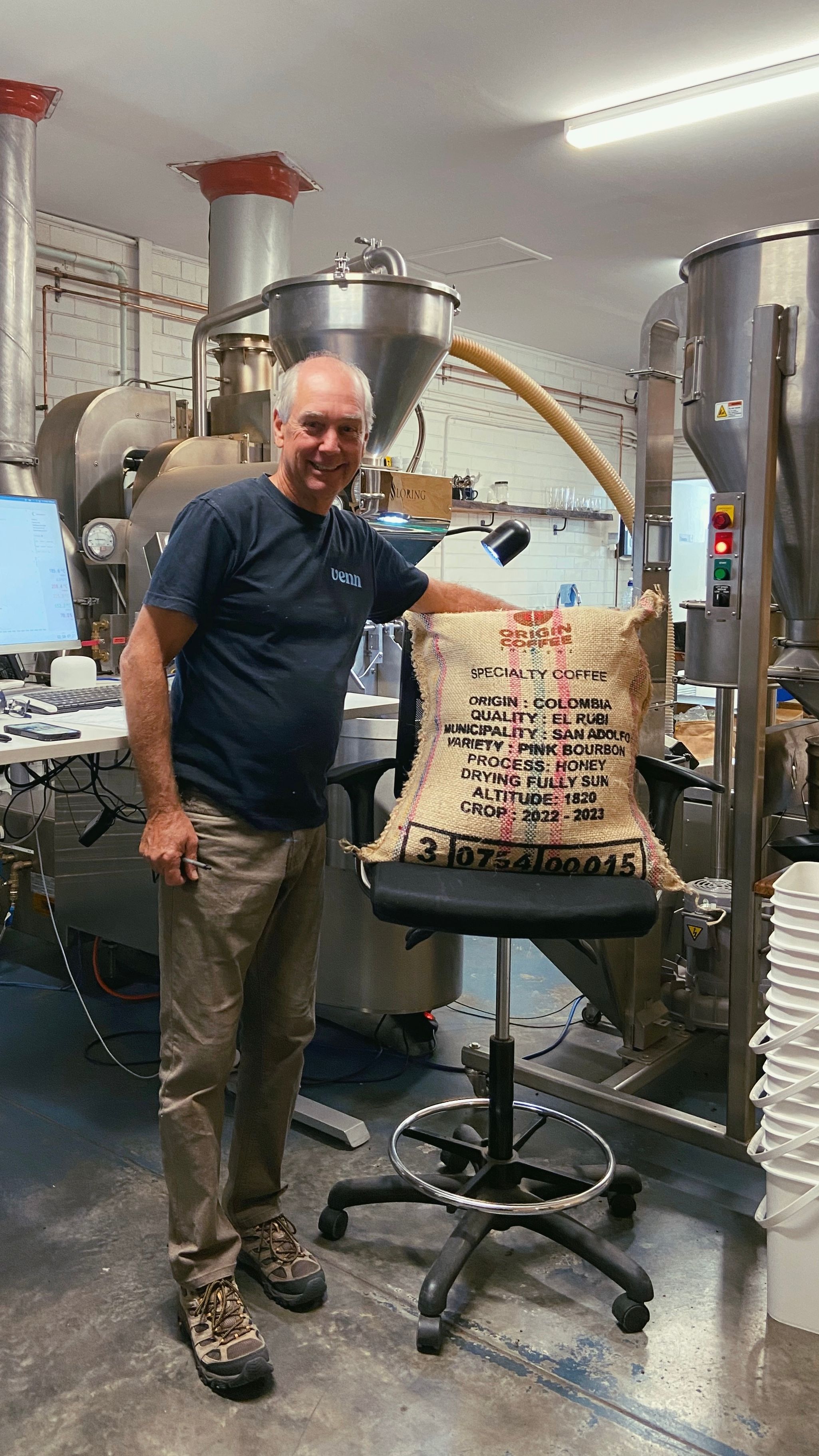Steve is at the roastery with his arm around a hessian bag of the new El Rubi coffee beans 