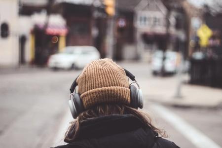 Woman wearing headphones on the street