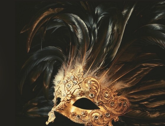 Dark feathers and a gold masquerade mask from the 2025 Hope for Heroes Gala invitation