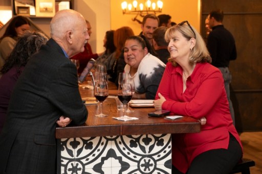 Attendees browsing the tasting tables at Sip, Savor, & Salute