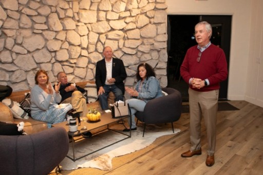 Guests raising a toast at the Sip, Savor, & Salute Veterans Day weekend fundraiser