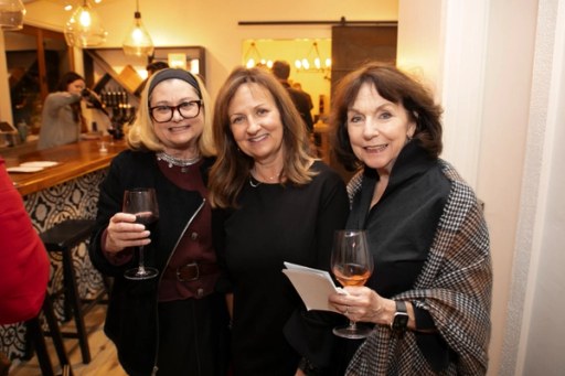 Guests posing together at the Sip, Savor, & Salute fundraiser