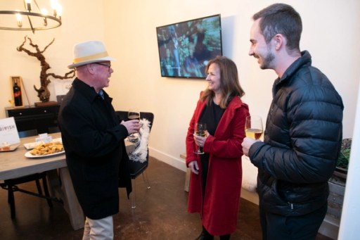 Attendees browsing the tasting tables at Sip, Savor, & Salute