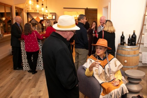 A candid moment among guests at Twisted Roots Winery during Sip, Savor, & Salute