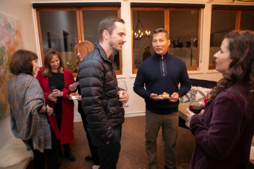 Guests gathered under the string lights at Sip, Savor, & Salute