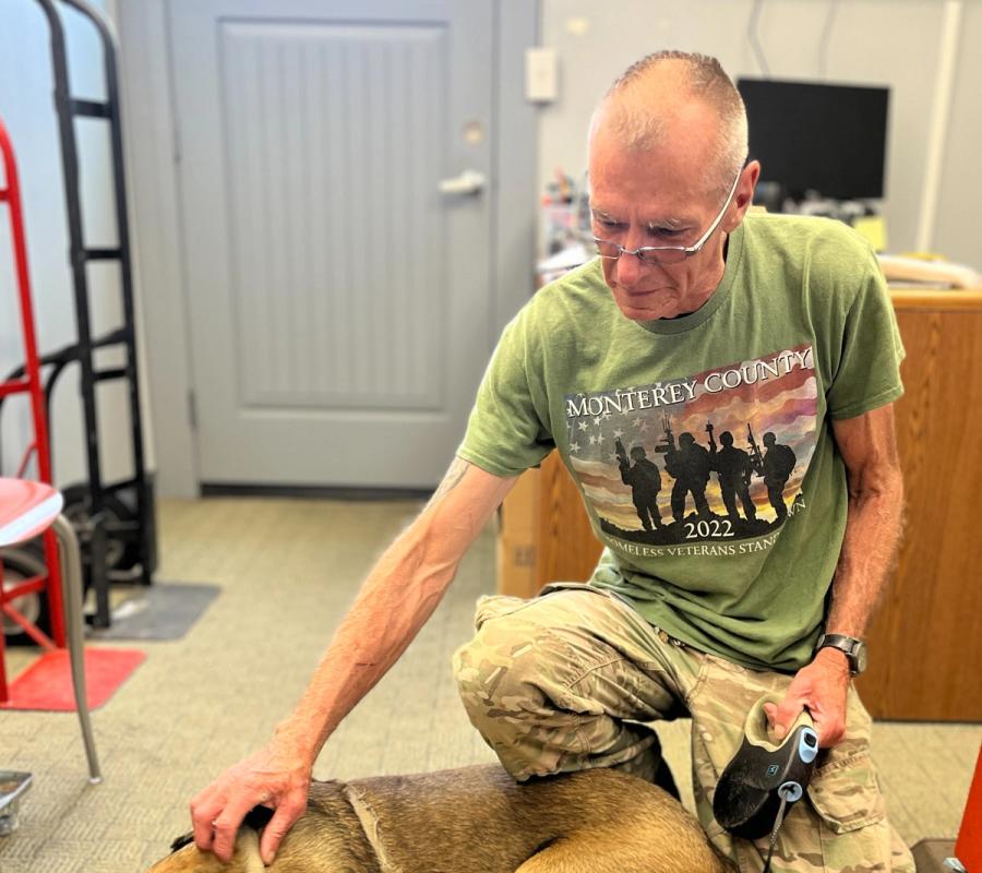 VTC graduate Kevin sitting with his dog Bandit