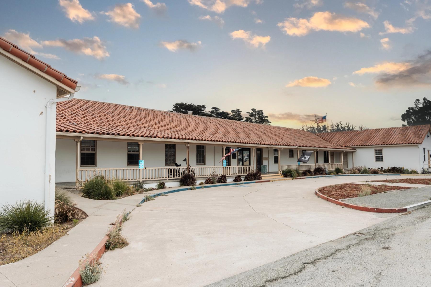 The historic red-tile-roofed VTC campus at Fort Ord — flags flying over the front porch