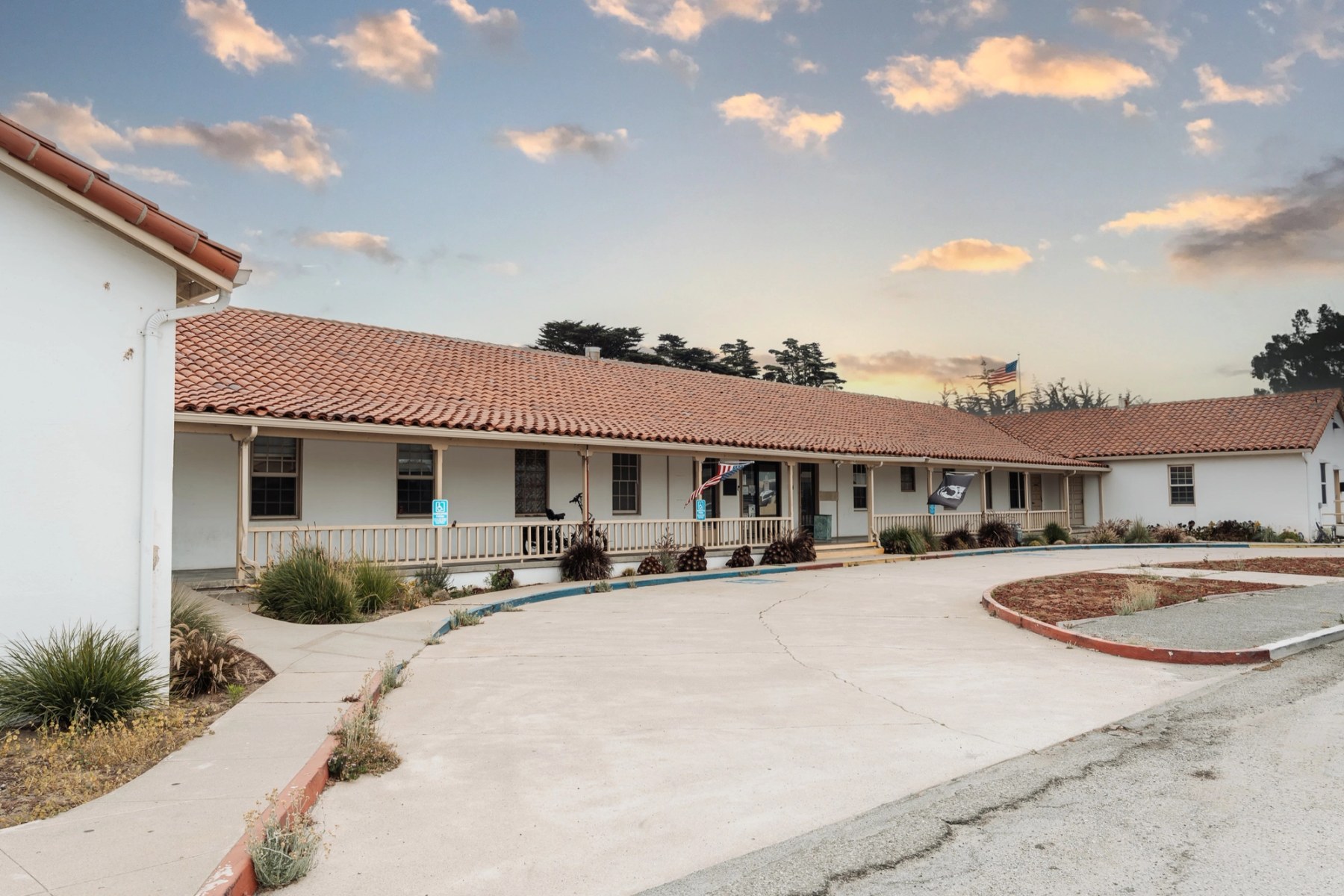 The historic red-tile-roofed VTC campus at Fort Ord — flags flying over the front porch