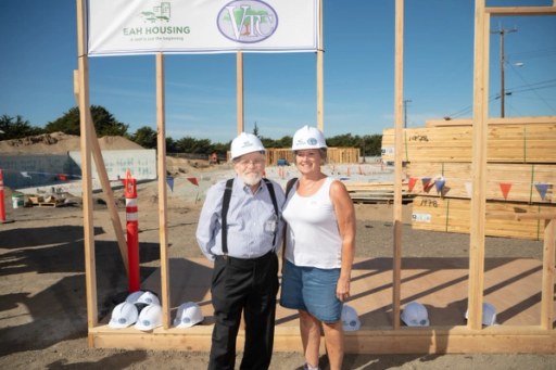 Community members at the Lightfighter Village wall raising