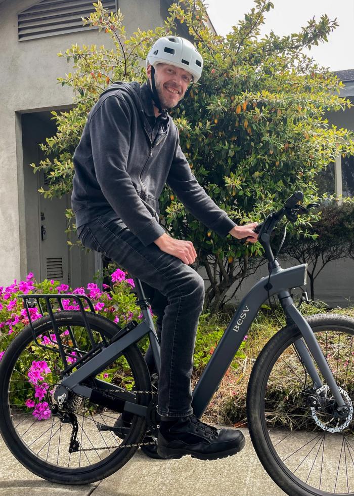 A VTC graduate with the e-bike that carries him to work