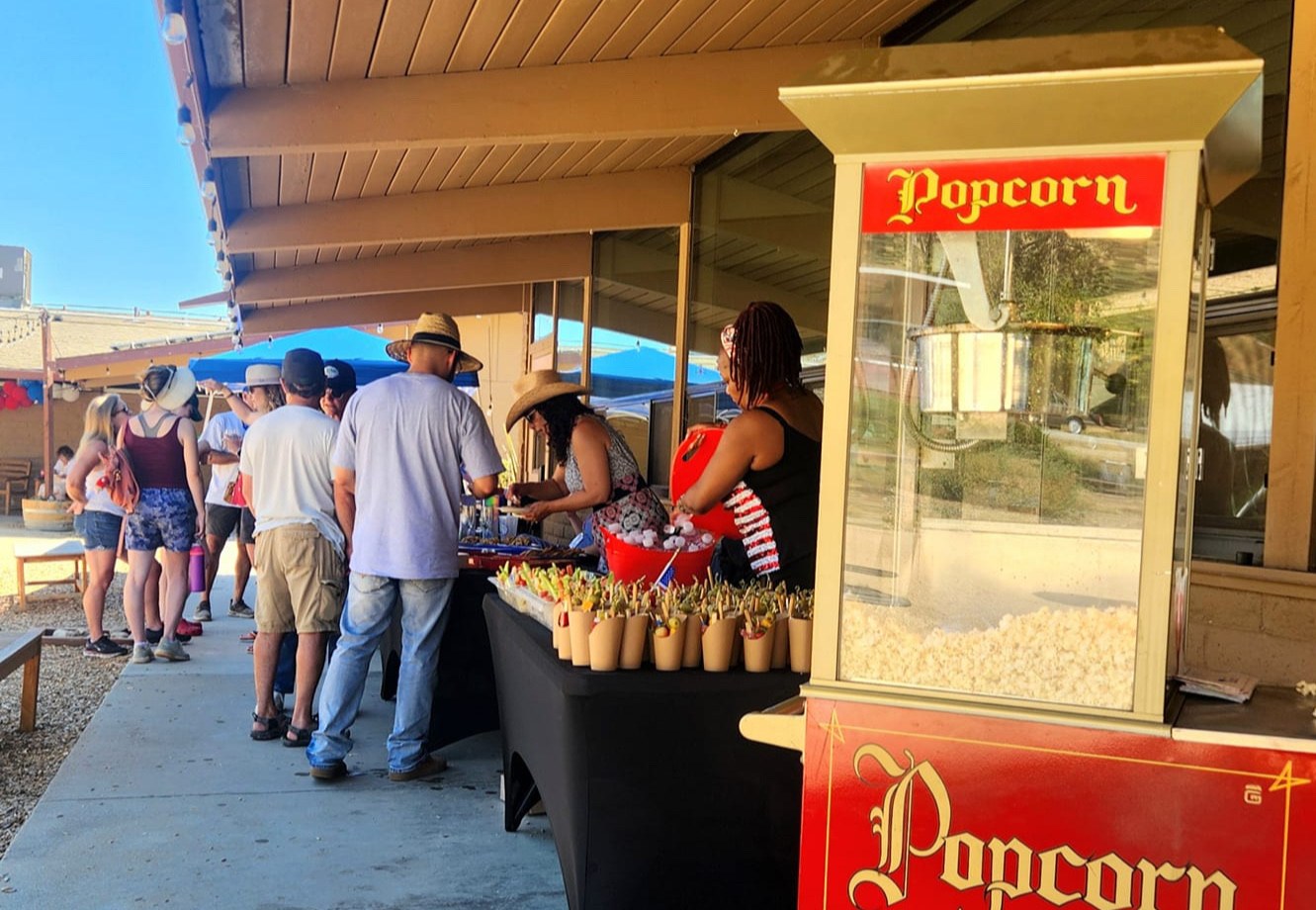 Guests line up beside the popcorn cart at the Celebration of Freedom