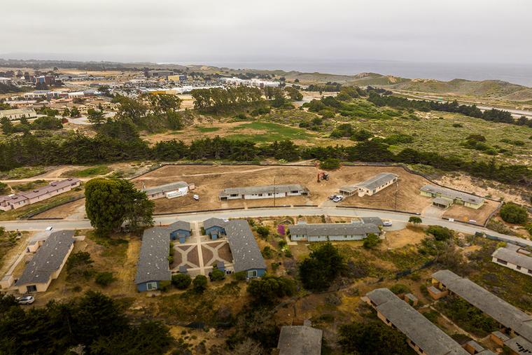 Framing rises over the village site
