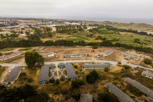 Framing rises over the village site