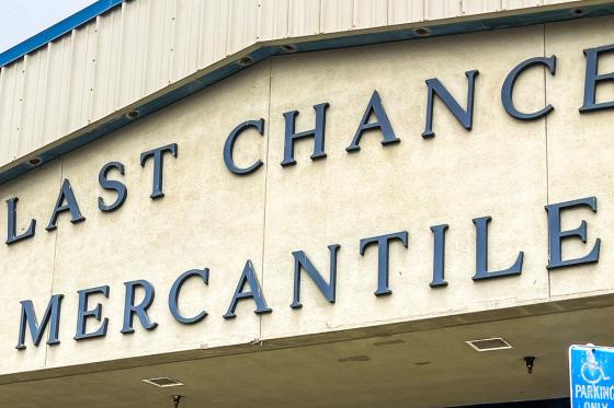 Large blue Last Chance Mercantile lettering across the front of the thrift store building