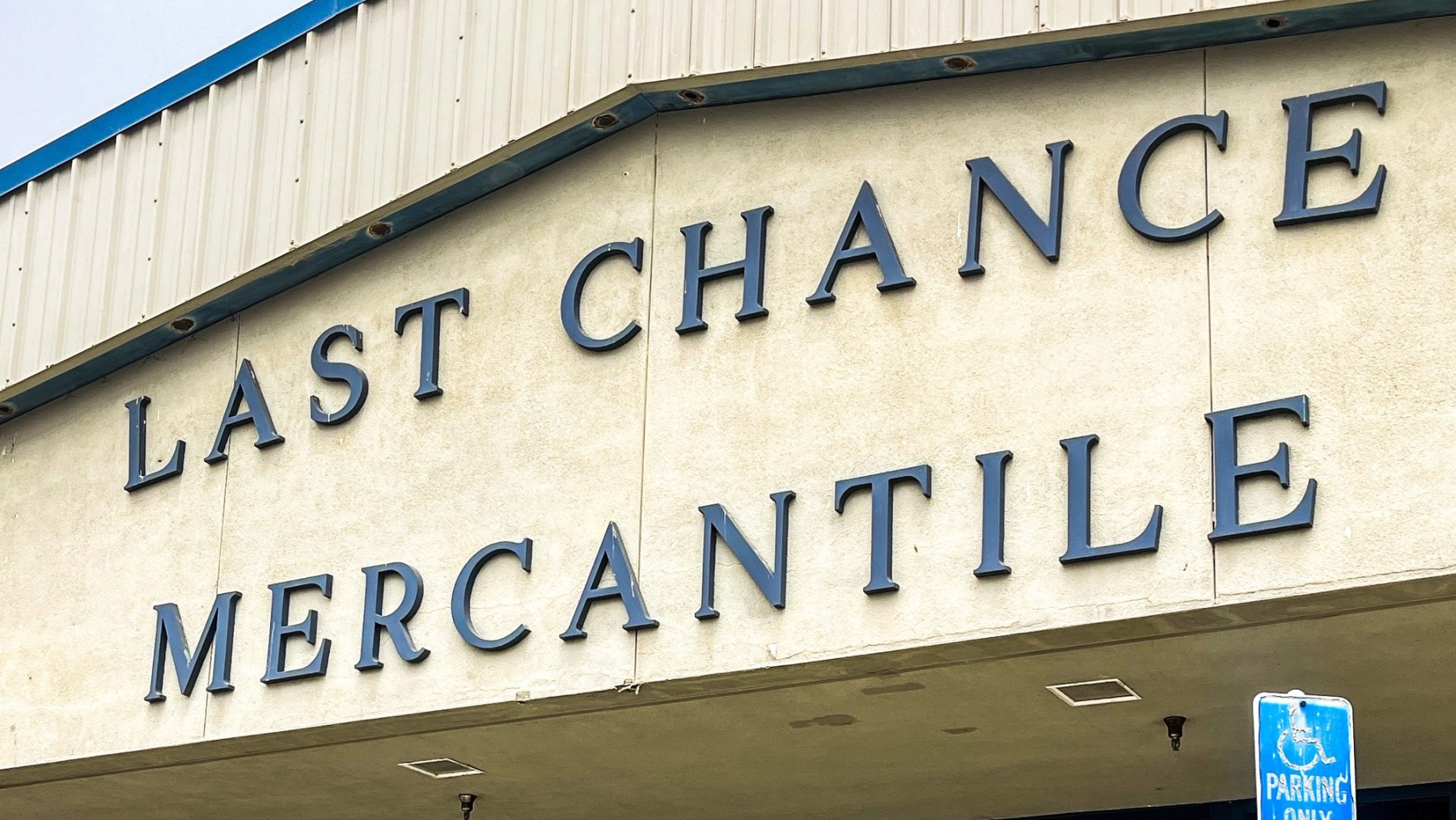 Large blue Last Chance Mercantile lettering across the front of the thrift store building